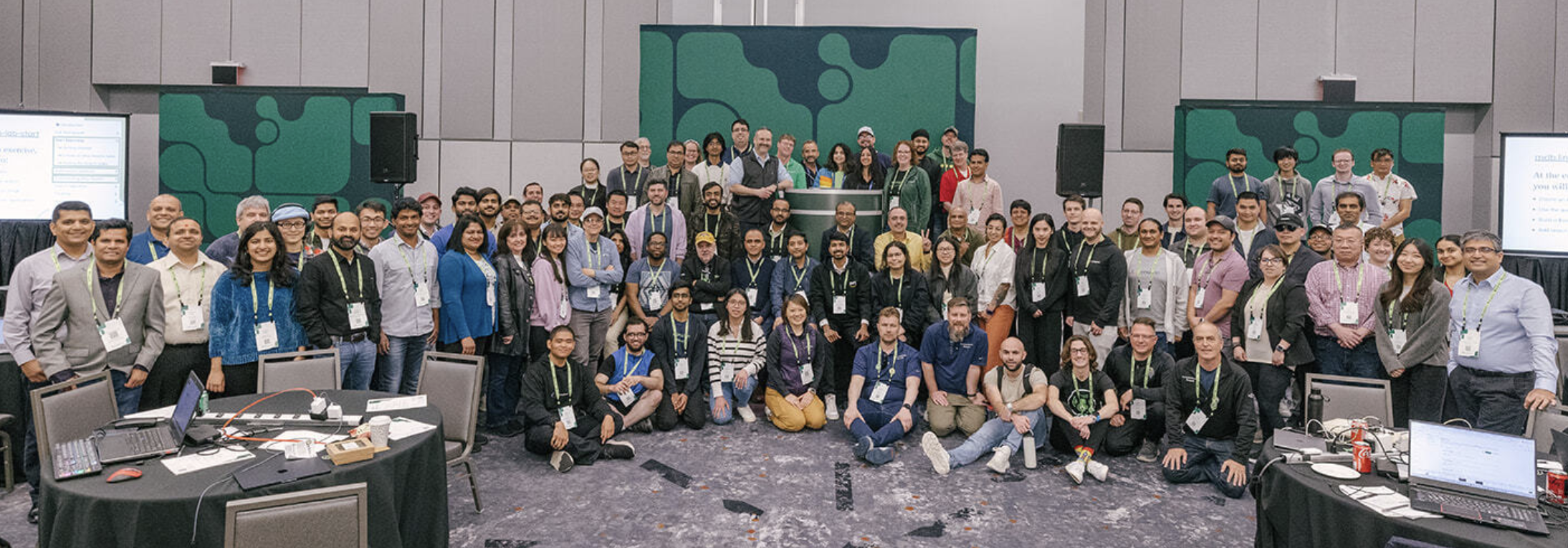 Photograph of the Developer Day class at MongoDB.local New York City. There are roughly 70 people in the photo standing in front of the presentation stage. 